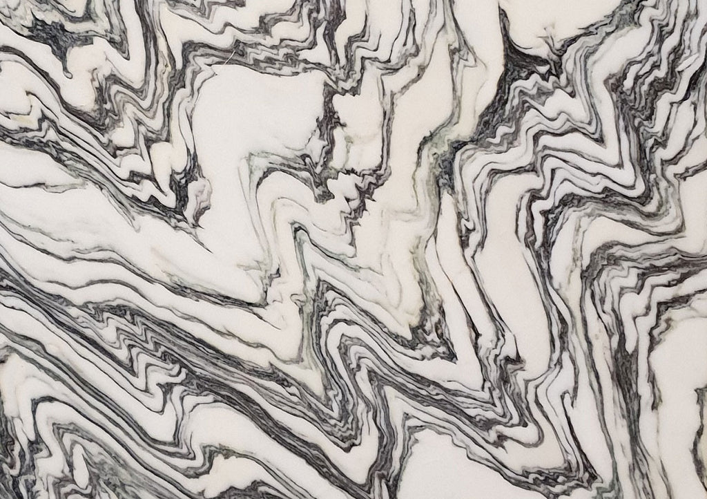 Close-up of Arabescato Fantastico marble with flowing black and grey veining on a white background
