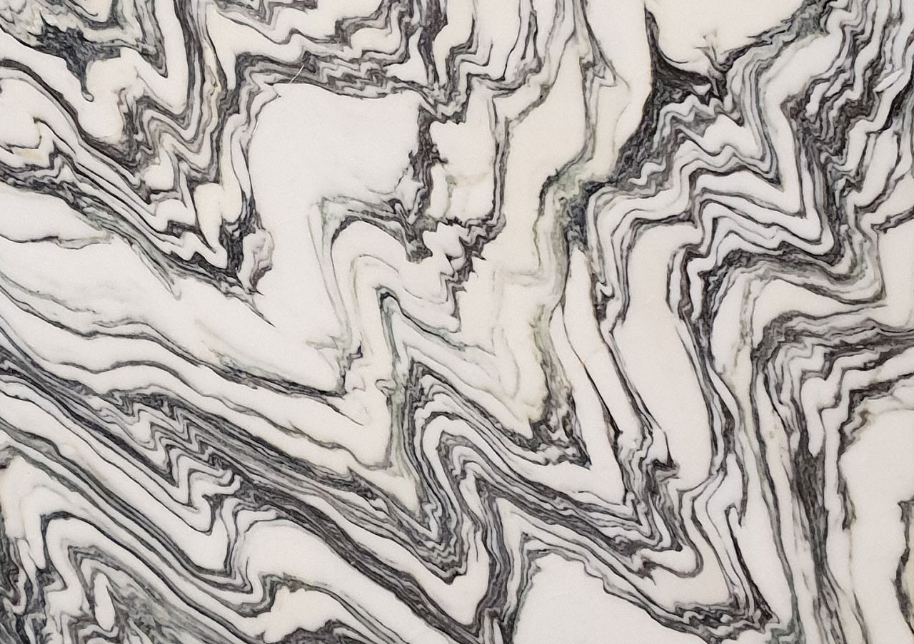 Close-up of Arabescato Fantastico marble with flowing black and grey veining on a white background
