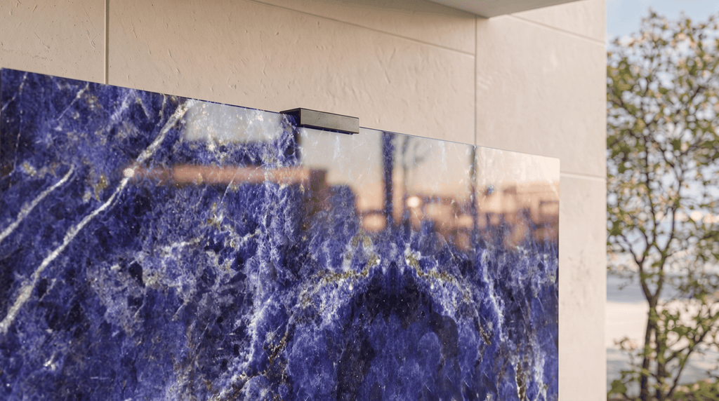 Close-up of Sodalite Blue gemstone Halo Screen with polished blue mineral surface and matte-black top clamp in daylight