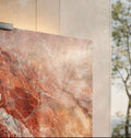 Close-up of Rouge des Carpates marble Halo Screen with rich red veining, polished surface, and matte-black top clamp in natural light